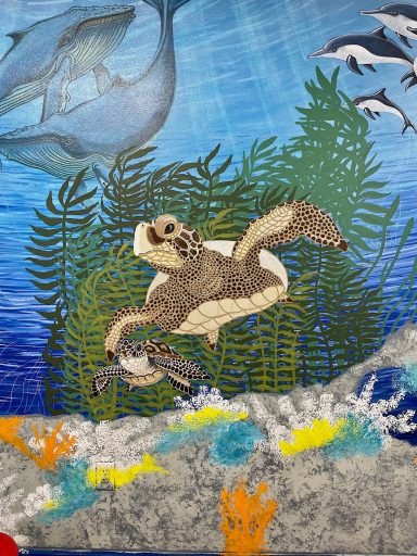 Mural of creatures in the ocean, sea turtle, dolphins, etc.