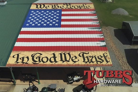 Mural on roof of building with U. S. A. Banner and "We the People. In God we trust."