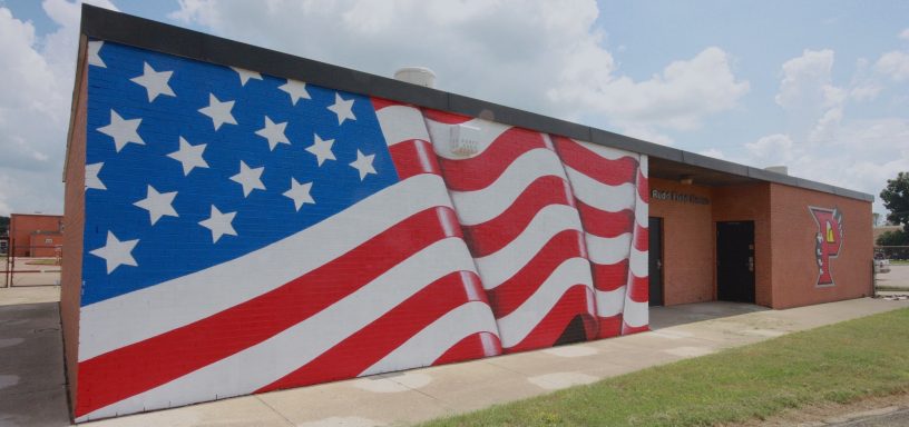 Mural painted on side of Parkway school building of an U. S. A. Banner