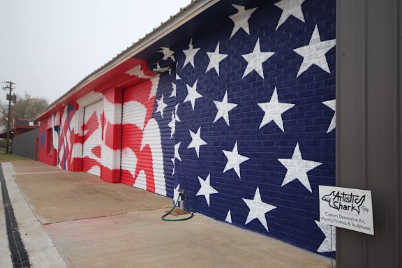 Mural of U. S. A. Banner on side of school building