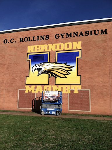 Mural on side of school building with "Herndon Magnet"