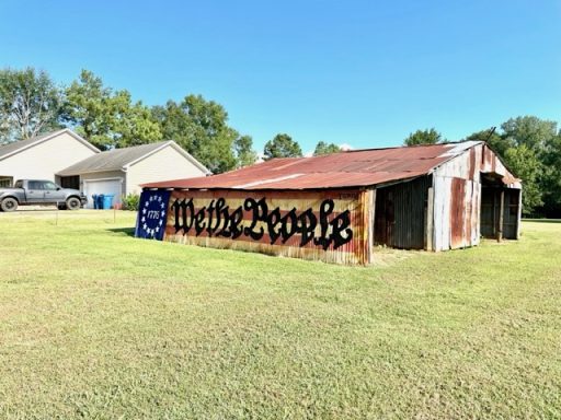 Mural painted on side of a barn with U. S. A. Banner and "We the People"